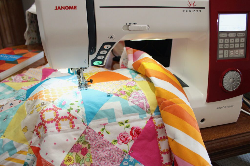 Machine quilting scrappy baby quilt